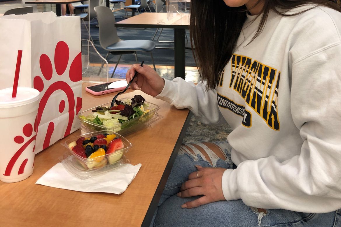 Student enjoying cup of fresh fruit from Chick-fil-A at the Mountainlair