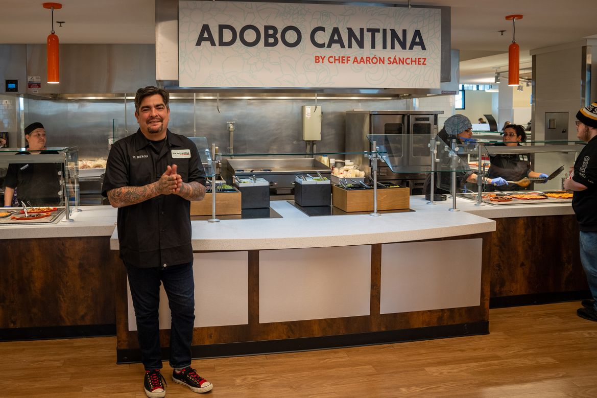 Chef Aarón Sánchez stands in front of Adobo Cantina, a new Mexican food station at Cafe Evansdale.