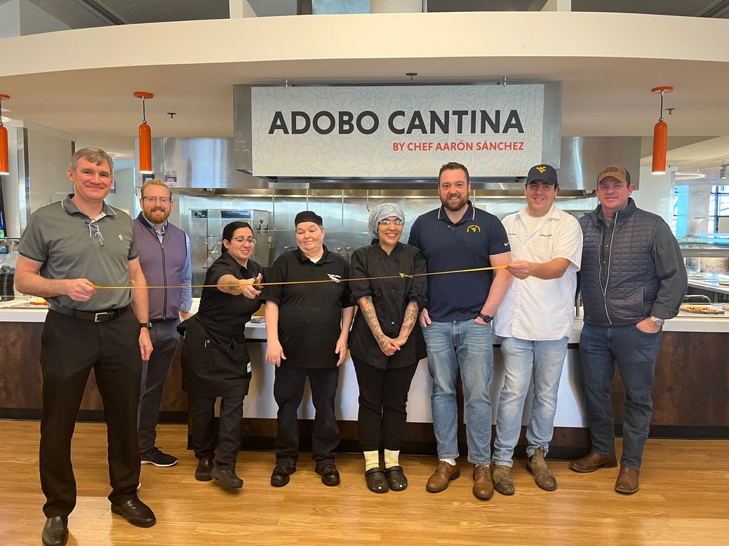 Chef Monica, along with her team, cuts the ribbon at the grand opening of Adobo Cantina at Cafe Evansdale.