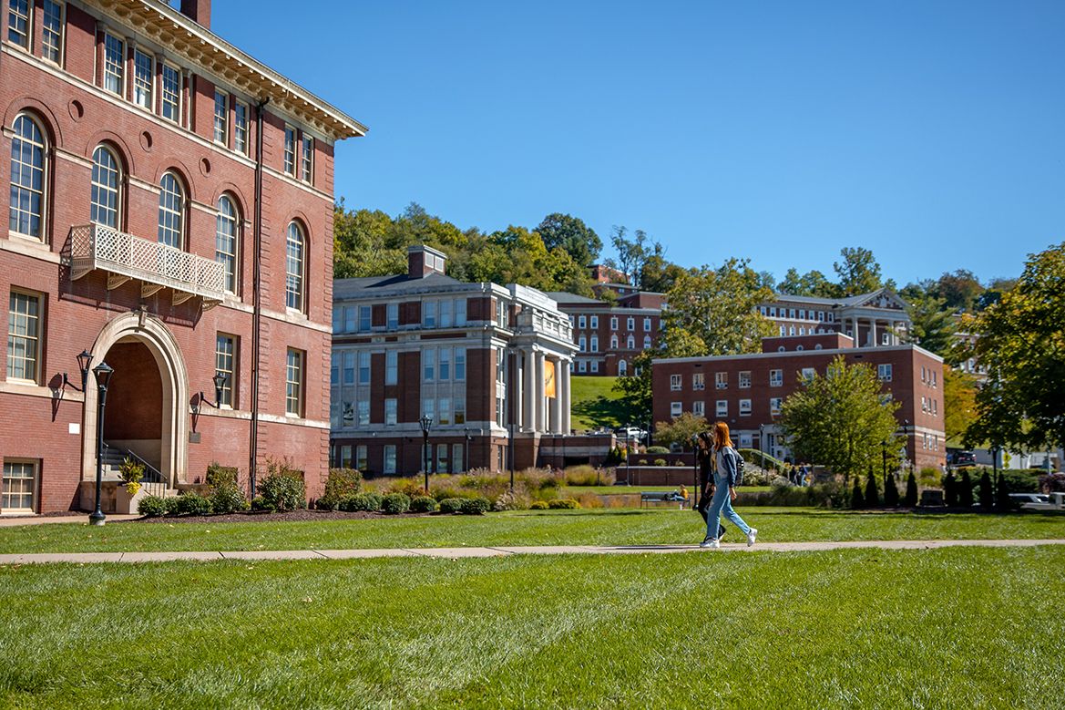 Two students walk on the sidewalk that connects Martin and Chitwood Halls on the Downtown campus
